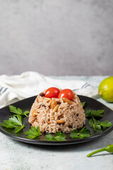 Rice rice with pine pistachios and almonds on a gray floor. Bademli ic pilavı. Appetizer varieties. Ramadan food