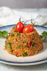 Bulgur salad on gray background. Traditional Turkish Bulgur Salad or kısır salatası. Close up