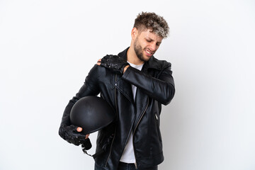 Young man with a motorcycle helmet isolated on white background suffering from pain in shoulder for having made an effort