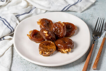 Fig dessert with sherbet on gray background. Walnut Filled Fig Dessert. Local name hatay incir tatlısı