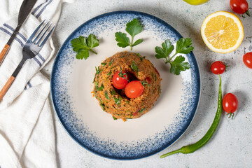 Bulgur salad on gray background. Traditional Turkish Bulgur Salad or kısır salatası. Top view