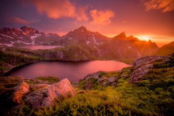An amazing sunset over two lakes and a waterfall.