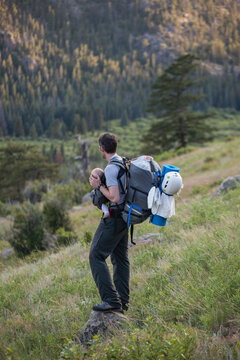 A man hikes with his baby daughter on the Ypsilon Lake Trail, Rocky Mountain National Park, Colorado.