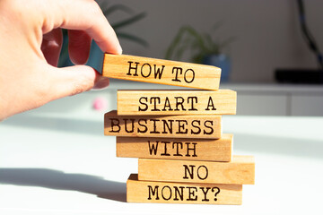 Wooden blocks with words 'How To Start a Business With No Money?'.