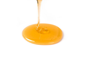 Pouring honey isolated on white background