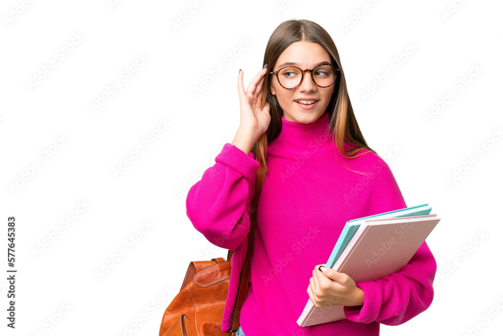 Canvas Prints Teenager student caucasian girl over isolated background listening to something by putting hand on the ear