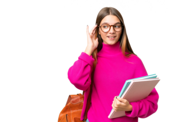 Teenager student caucasian girl over isolated background listening to something by putting hand on the ear