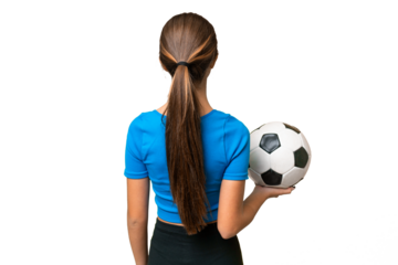 Teenager caucasian girl playing football over isolated background in back position