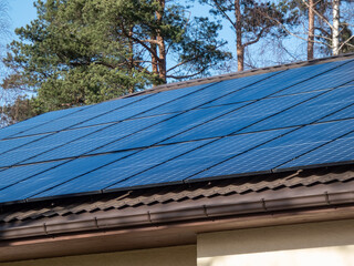 Roof with mounted and installed photovoltaic solar panels on the roof. Rooftop with solar cells for...