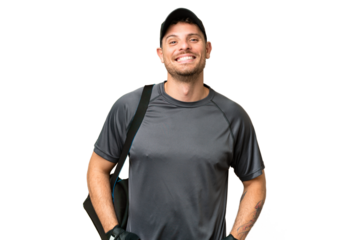 Young sport man with sport bag over isolated chroma key background laughing