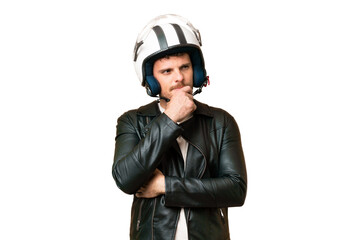 Brazilian man with a motorcycle helmet over isolated chroma key background having doubts and...