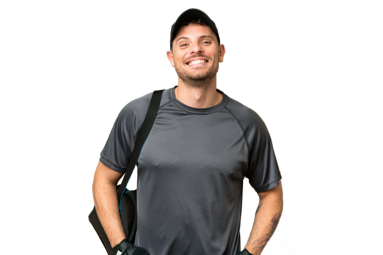 Young sport man with sport bag over isolated chroma key background laughing
