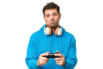 Brazilian man playing with a video game controller over isolated chroma key background © luismolinero
