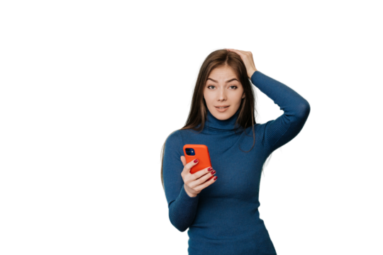 Puzzled young girl with long hair in blue sweater, holding  phone, looking at camera, touching head, thinks what to do after receiving news. Hesitating girl using phone against transparent background