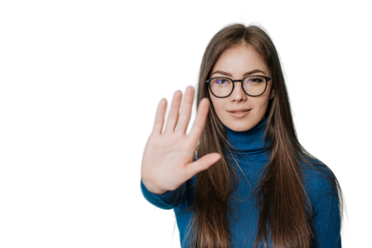 Stop! Stay away! A young European girl in a dark blue jumper and pants put her hand in front of her in a stopping gesture, standing on transparent background..Student trying to avoid bullying.