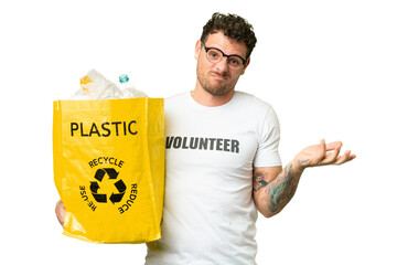 Brazilian man holding a bag full of plastic bottles to recycle over isolated chroma key background...