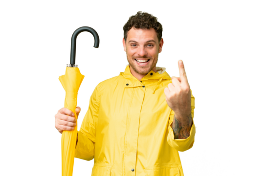Brazilian man with rainproof coat and umbrella over isolated chroma key background doing coming gesture