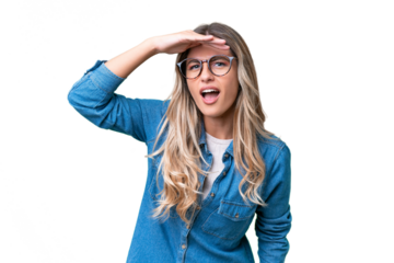 Young Uruguayan woman over isolated background looking far away with hand to look something