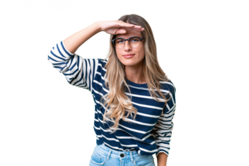 Young Uruguayan woman over isolated background looking far away with hand to look something