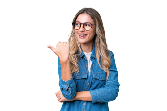 Young Uruguayan woman over isolated background pointing to the side to present a product