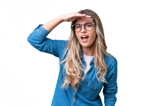 Young Uruguayan woman over isolated background looking far away with hand to look something