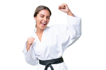 Young Uruguayan woman doing karate over isolated background celebrating a victory