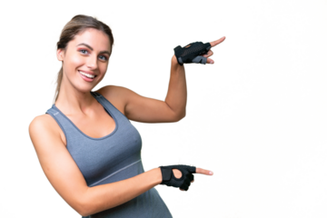 pretty Sport Uruguayan woman over isolated background pointing finger to the side and presenting a product