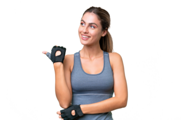 pretty Sport Uruguayan woman over isolated background pointing to the side to present a product
