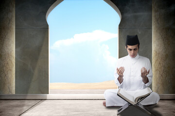Fototapeta na wymiar Muslim man sitting while raised hands and praying