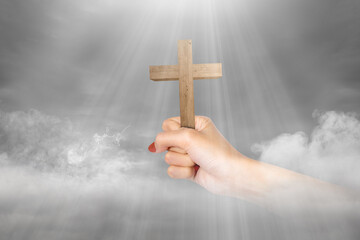 Human hand holding Christian cross