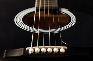 Guitar black, string instrument, six strings stretched, polished smooth soundboard, lower...