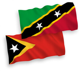 Flags of Federation of Saint Christopher and Nevis and East Timor on a white background