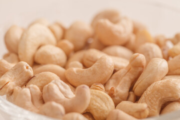 Cashew nuts piled pile, side view, selective focus