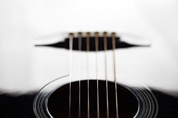 Fototapeta premium Guitar black, six stringed plucked musical instrument, lower threshold, close-up selective focus