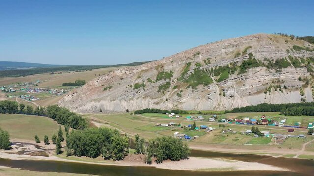 Southern Urals, Bashkiria: the Zilim River near the village of Tash-Asty, the Ukly Kaya rock, the tourist attraction Heart of Bashkiria. Aerial view.