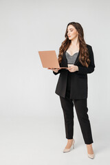 Young businesswoman using laptop against white background, copy space