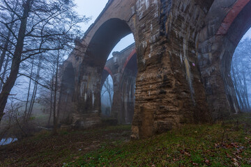 Fototapeta na wymiar Old concrete railway bridge in Stanczyki, Mazury, Poland