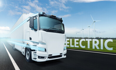 Concept of white electric truck on a road with wind turbines on a horizon