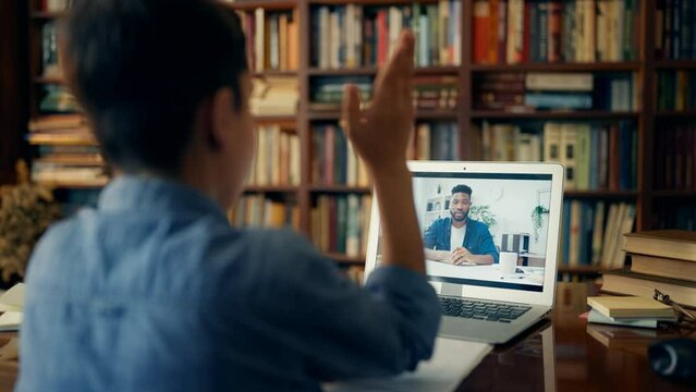 Schoolboy talking with private tutor during online lesson, distance education