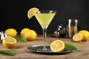 Lemon Martini cocktail and fresh fruits on wooden table