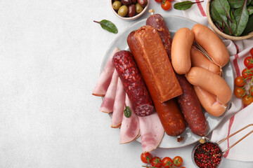 Different types of tasty sausages and ingredients on white table, flat lay. Space for text