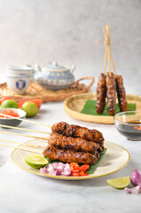 Singapore Pork Satay Version that presented with sweet ketchup, chili and lime isolated on white background
