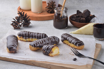 An éclair is a pastry made with choux dough filled with a cream and topped with a flavored icing.
