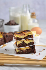 A chocolate cheese brownie or simply a brownie is a chocolate cheese  baked confection. Brownies come in a variety of forms and may be either fudgy or cakey, depending on their density. 
