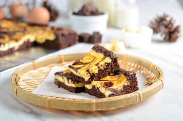 A chocolate cheese brownie or simply a brownie is a chocolate cheese  baked confection. Brownies come in a variety of forms and may be either fudgy or cakey, depending on their density. 
