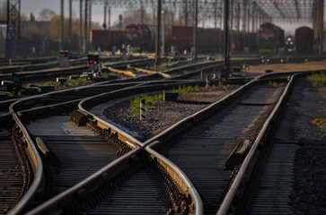 Fototapeta premium Railway Network In Lithuania. Radviliskis is well known railway capital in Lithuania. Beautiful evening sunset light and cars in background.