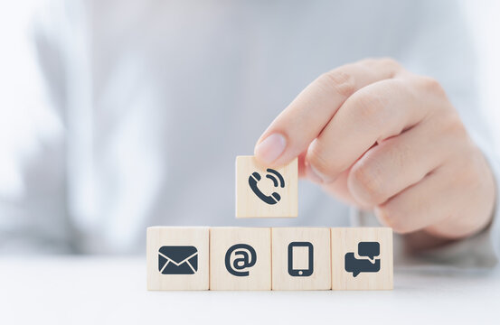 hand holding wooden blocks and communication icons