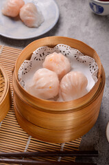 Traditional Asian Prawn or shrimp dumplings hakau, ha kauw or har gow. Served with cabbage, carrot salad and soy and sweet chilli sauce
