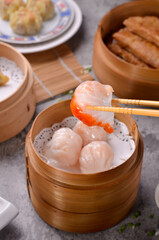 Traditional Asian Prawn or shrimp dumplings hakau, ha kauw or har gow. Served with cabbage, carrot salad and soy and sweet chilli sauce

