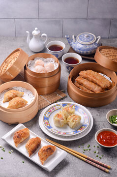  A Chinese dish of small steamed or fried savory dumplings containing various fillings, served as a snack or main course.
